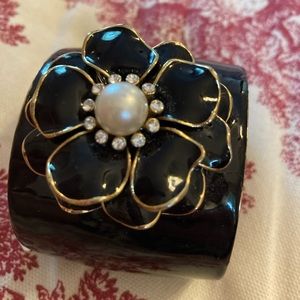 Adorable black cuff bracelet with decorative flower with rhinestones